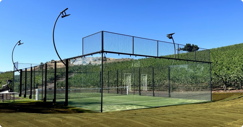 Panoramic outdoor padel court with green surface